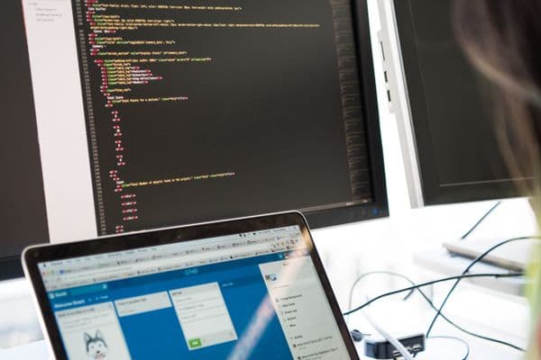 Developer coding on workspace monitor